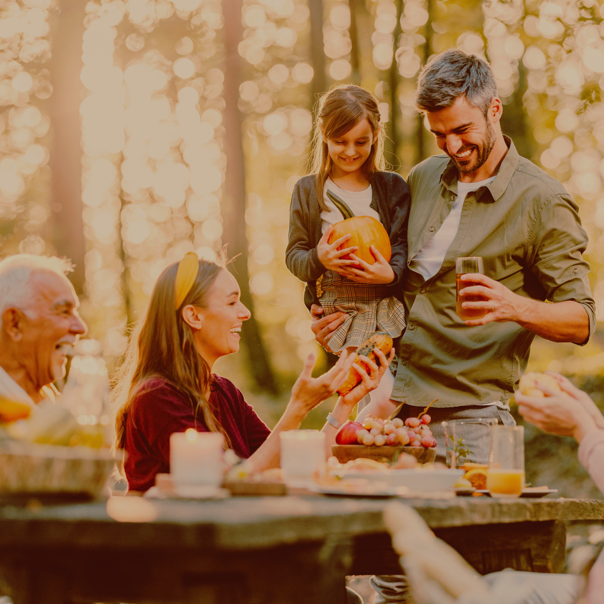 Multi-generation family enjoying an outdoor meal in autumn