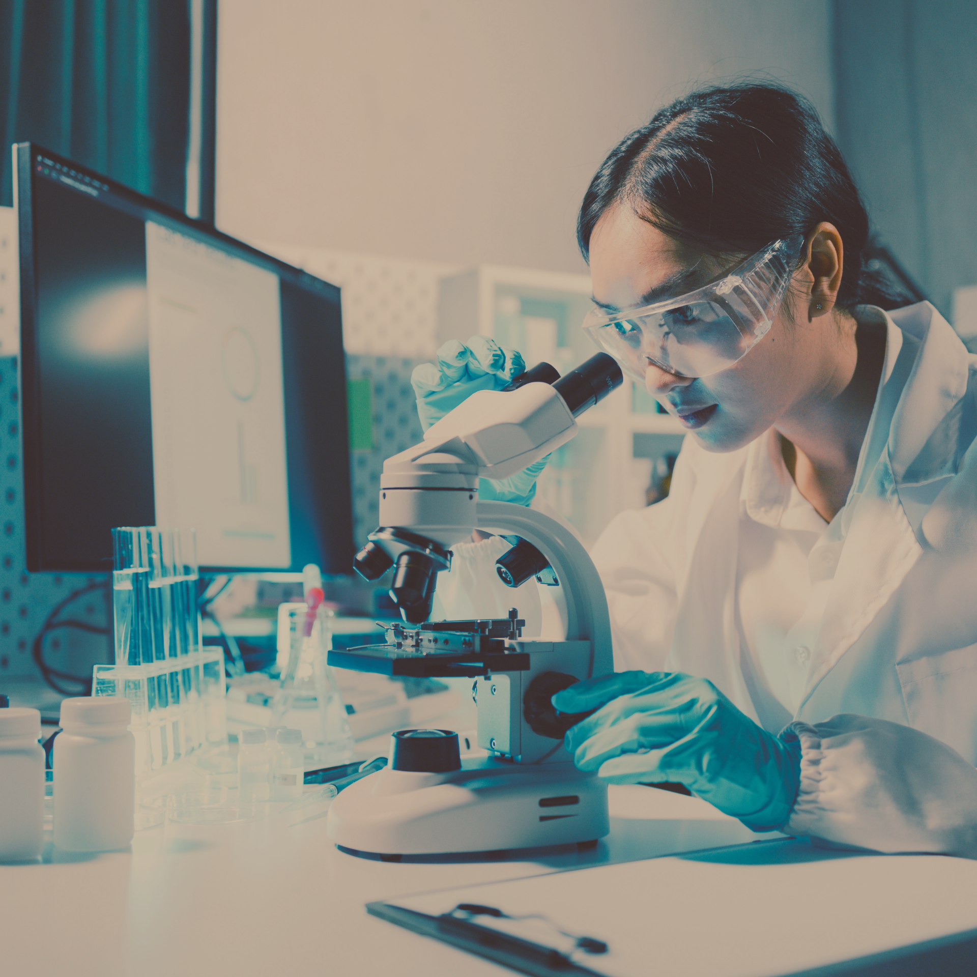 Woman in a lab doing research on a microscope